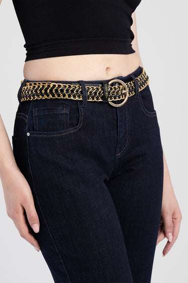 gold chain belt with a round metal buckle worn over dark blue denim jeans