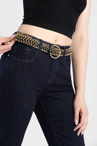 two tone chain belt with gold links and black strap around the waist over dark denim jeans with a circular ring buckle