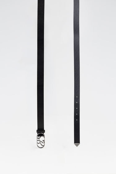 black leather belt with a silver buckle and a row of small holes, long and slim with a metal tip