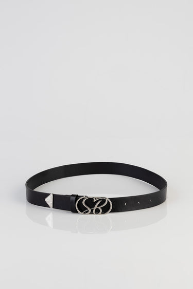 black leather belt with a silver heart buckle and initials, small triangle tag near the buckle, on a white surface