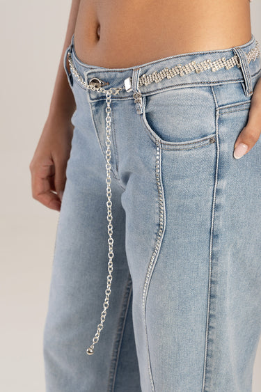 light blue denim jeans with a sparkling rhinestone belt and silver chain detail at the hip