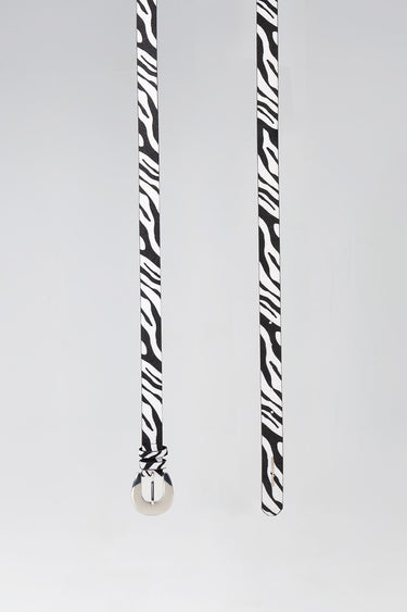 zebra print belt with a silver round buckle hanging vertically