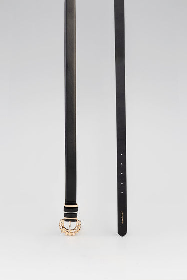 two black belts hanging vertically, one featuring a gold coil ring buckle at the bottom