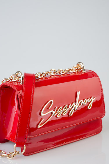 red patent leather crossbody bag with a gold chain strap and a cursive logo plaque