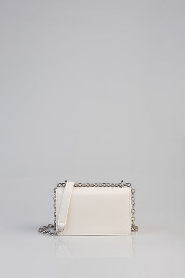 cream crossbody bag with a silver chain strap and stitched edges