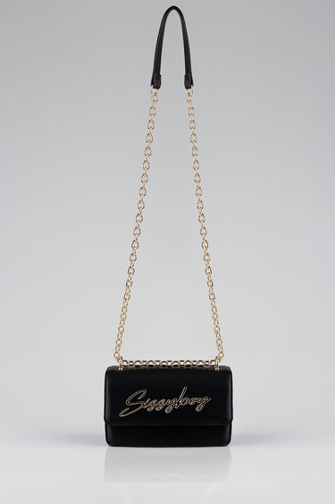 black crossbody bag with a gold chain strap and a signature cursive logo on the front
