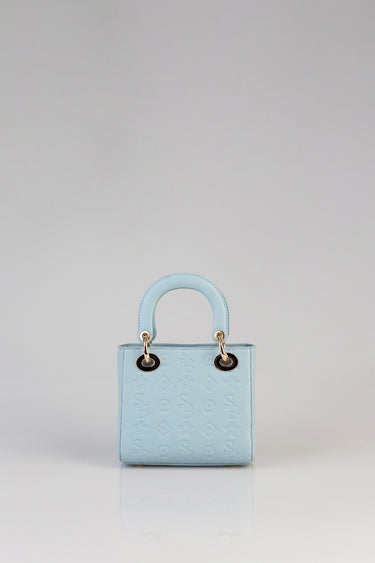 light blue mini tote bag by Blue Jean Traders with rounded handles and gold rings, embossed pattern.