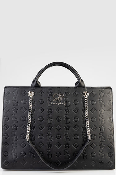 Blue Jean Traders black tote bag with embossed geometric and floral pattern, two top handles and a silver chain strap