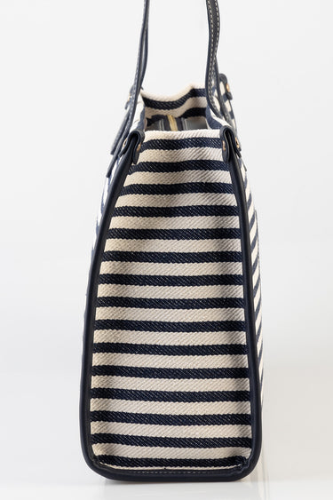 navy and cream striped tote bag with dark blue leather trim and handles