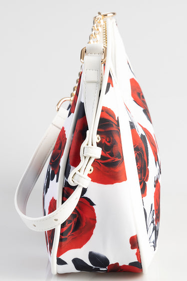 side view of white bag with red rose print, gold chain strap and white handle, by Blue Jean Traders