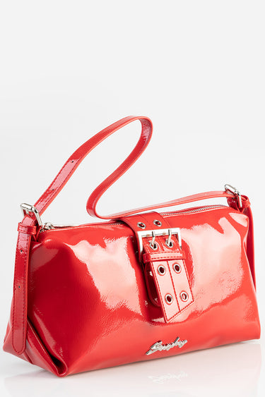 red patent leather shoulder bag with a silver buckle and top handle, Blue Jean Traders logo visible.