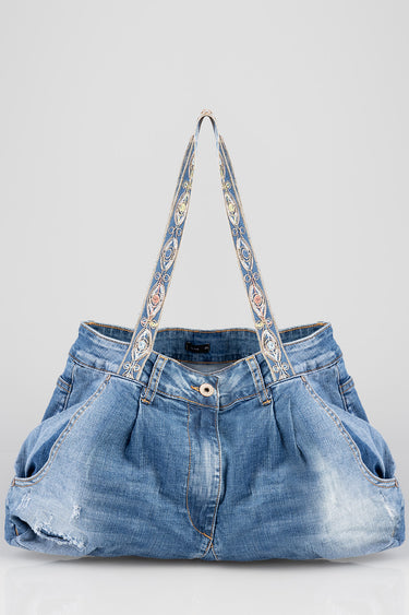 blue denim tote bag with wide patterned straps and front pockets