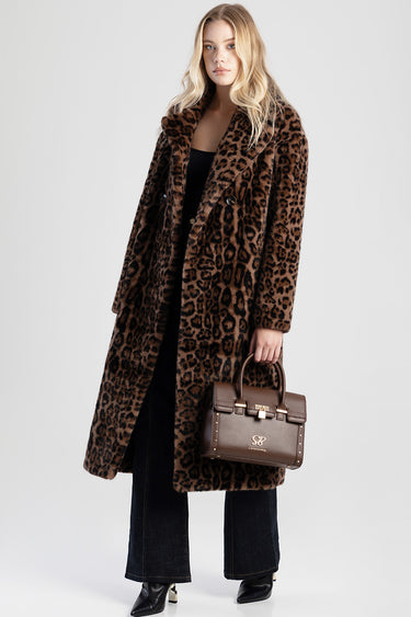 model wearing a leopard print faux fur coat and carrying a brown structured handbag with gold hardware