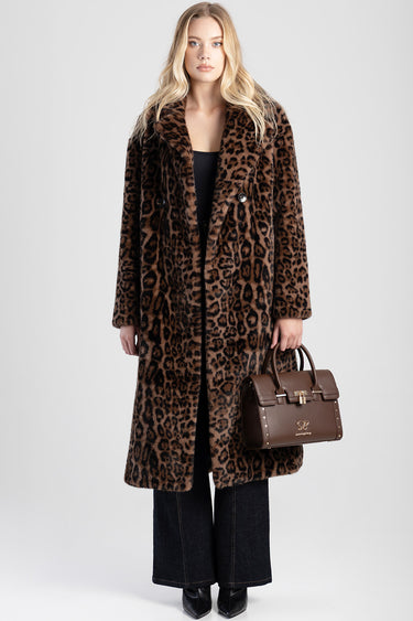 woman wearing a long leopard print coat and black outfit, holding a brown structured handbag.