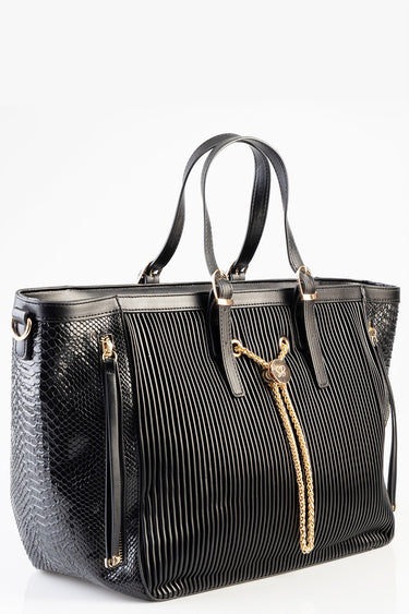 black handbag with pleated front panels snakeskin textured sides and gold tone hardware with a decorative tassel