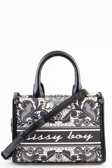 mini bag with black and white lace pattern, black leather trim, top handles, and detachable strap
