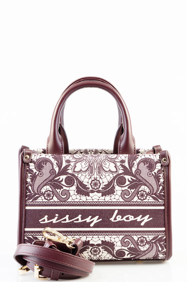 burgundy handbag with ornate cream and burgundy lace pattern, rounded handles and a detachable strap with gold hardware.