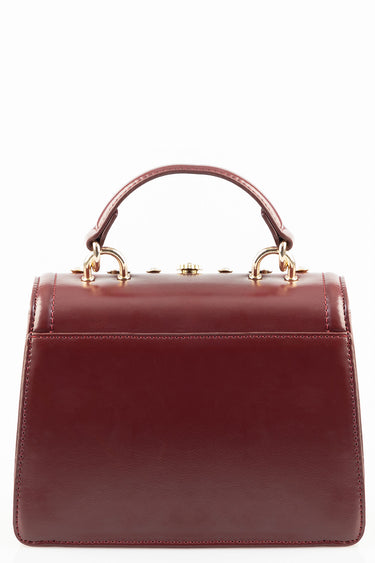 mini handbag in burgundy leather by blue jean traders with a top handle and gold hardware