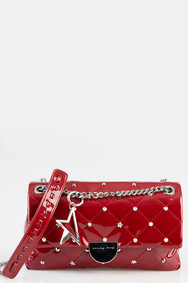 red patent quilted handbag with silver studs, chain strap and star charm