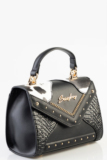 black handbag with white patch, snake-embossed sides, gold chain trim and rivets, top handle