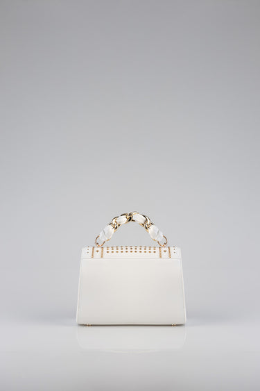 white tote bag with a chunky gold chain handle and studded detailing across the top