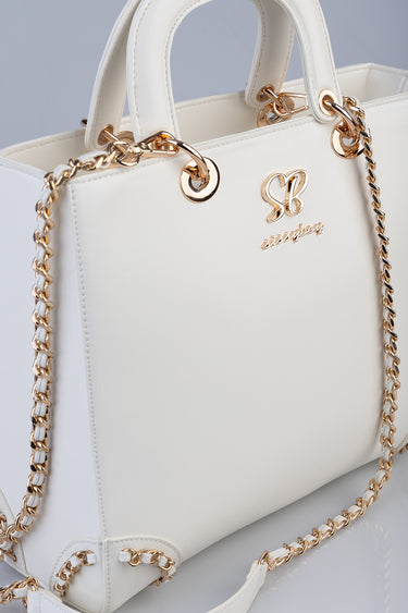 white leather briefcase style bag with gold chain shoulder straps and handles