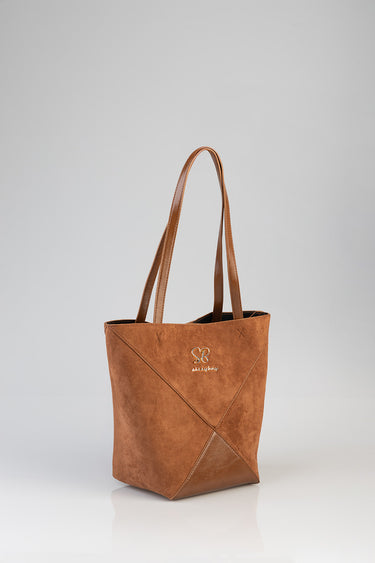 brown suede shopper tote with long tan handles and a small gold logo on the front