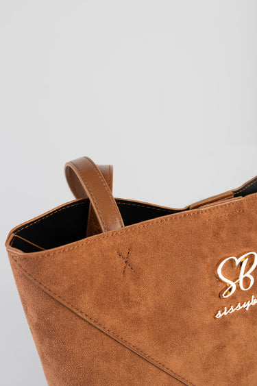 brown suede shopper bag with two top handles and a white script logo on the front