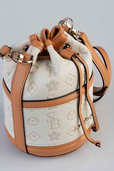 mini bucket bag with cream surface and tan leather trim, debossed monogram pattern, drawstring top and gold hardware