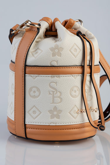blue jean traders mini bucket bag in cream and tan with a monogram pattern, leather trim and drawstring straps
