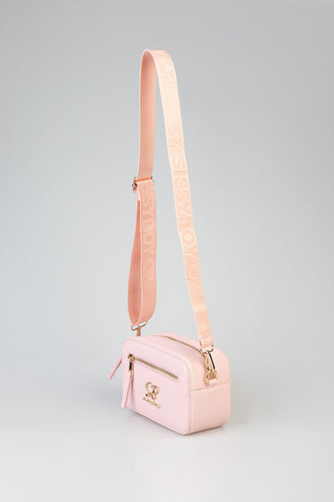 soft pink crossbody bag with front zip pocket, gold hardware and adjustable logo strap