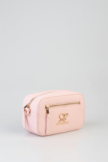 pink crossbody bag with gold zippers, small rectangular shape, front pocket and logo charm