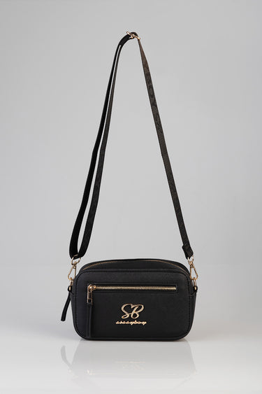 black crossbody bag with gold zip and front logo plaque, compact rectangular shape with two shoulder straps