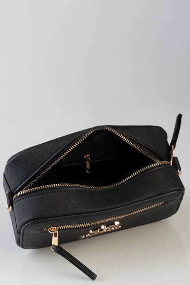 Blue Jean Traders crossbody bag with gold hardware and zippers, open main compartment and compact silhouette