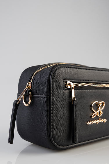 black crossbody bag with gold zippers and a gold front logo on textured material
