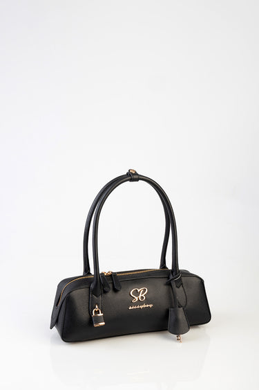 black leather handbag with two top handles, gold zippers, a gold logo on the front, and a tassel key fob