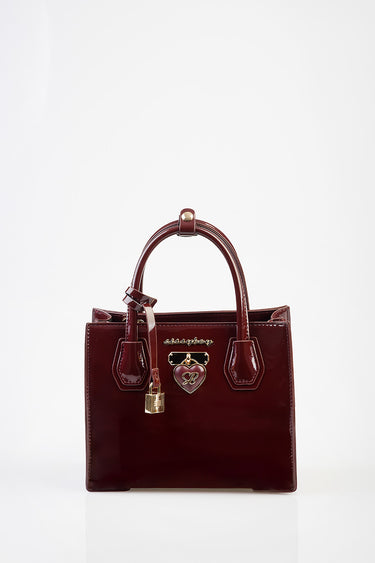 burgundy patent leather tote by Blue Jean Traders with short handles, gold hardware, lock charm and heart emblem