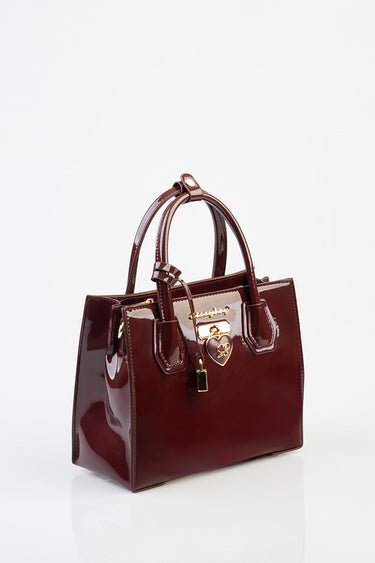 burgundy patent leather tote bag by Blue Jean Traders with gold hardware and heart lock charm