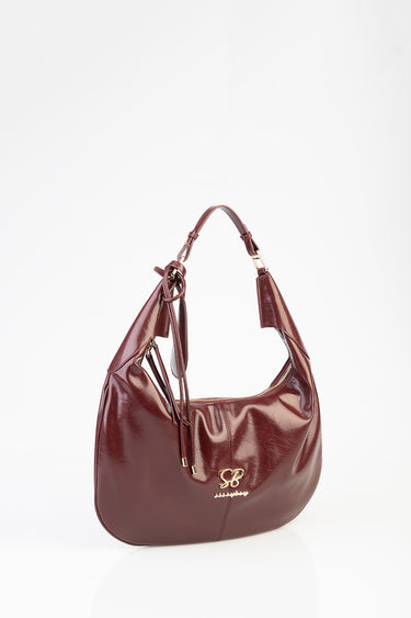 burgundy leather shoulder bag with gold hardware, zip top, tassel details and gold logo initials sb