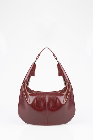 Blue Jean Traders burgundy leather shoulder bag with gold hardware and curved hobo silhouette