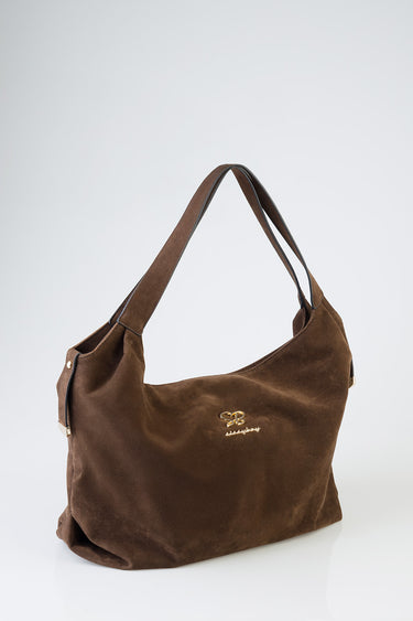 brown suede tote bag with wide double handles and a small gold logo on the front