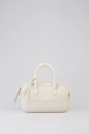 cream bowler bag with two top handles, embossed sissyboy lettering on the front, tassel zipper and gold hardware