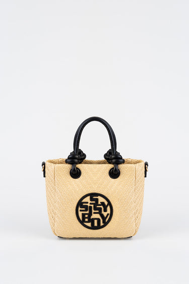 blue jean traders woven straw tote with black handles and a circular logo on the front