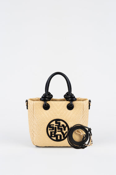 beige woven bag with black rounded handles, circular logo patch, and a detachable black strap by Blue Jean Traders