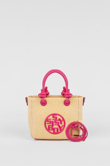 Blue Jean Traders straw tote with bright pink handles and a circular pink logo on the front; includes a detachable pink