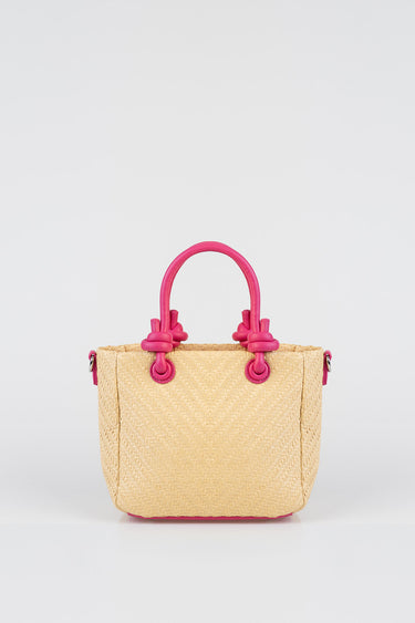 woven straw handbag with chevron texture and bright pink double handles and trim