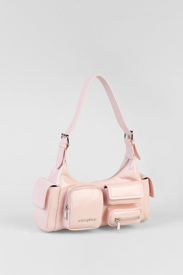 soft pink shoulder bag with multiple front pockets and zip closures on a white background
