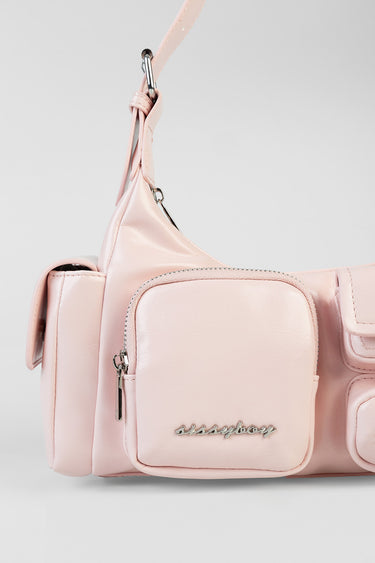 pink crossbody bag with a front zip pocket and silver hardware attached to a light pink strap