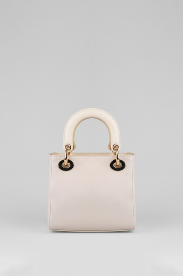 Blue Jean Traders mini handbag in soft beige with rounded top handles and gold metal ring attachments