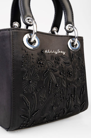 black mini bag with embroidered floral pattern and silver ring hardware, by Blue Jean Traders